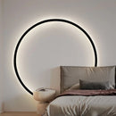 Image d'une lampe murale 'Circolo di Luce', un arc lumineux circulaire élégant en noir ou blanc, monté sur un mur avec une lueur chaude.